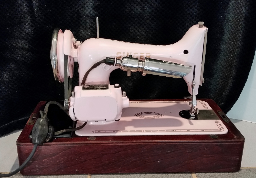 Beautiful pink Singer model 99 vintage sewing machine in bentwood case
